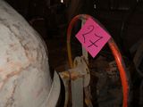 a cement mixer in a building with a pink sign on it