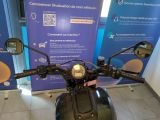 a motorcycle that is parked in front of a blue sign