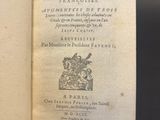 an open book on a table with a black background