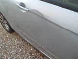 a car that is parked on a gravel lot