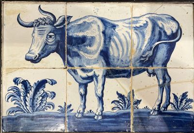 un carreau bleu et blanc sur lequel est représentée une vache