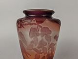a purple vase with a floral design on it