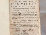 an old book on display in a glass case