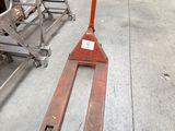 a fork lifter that is sitting in a warehouse