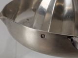a metal juicer that is sitting on a counter