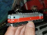 a person holding a toy train in their hand