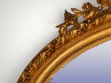 a mirror with a gold frame and a blue background