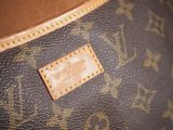 a close up of a louis vuitton bag with a leather label