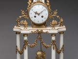 une horloge blanche et or posée sur une table