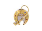 an image of a gold and diamond broochle with a cross on it