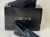 a pair of men ' s shoes in a box on a white background