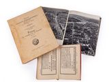 an old book opened to show an image of a city