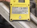a yellow electronic device that is being held by a person