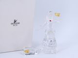 a glass figurine of a woman holding a goldfish