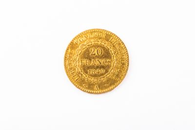 a close up of a gold coin on a white surface