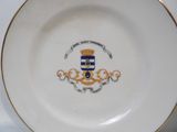 a plate with a coat of arms and a crown on it