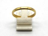 a close up of a gold ring on a white surface