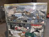 a metal cart with many items in it in a warehouse
