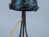 an old fashioned lamp with a blue glass shade and a yellow cord