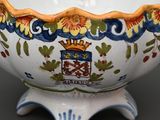 a white bowl with a blue and yellow design on it