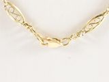 a close up of a gold necklace on a mannequin mannequin mannequin mannequin mannequin mannequin mannequin manne