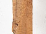 a piece of wood hanging from a hook on a wall