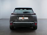 the rear end of a grey car in a white room