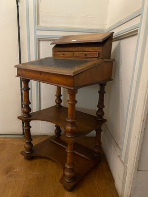 a small wooden table with a drawer on top of it