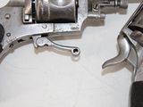 a gun that is sitting on a table next to a pair of scissors
