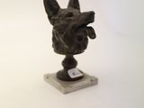 a statue of a dog that is sitting on a table