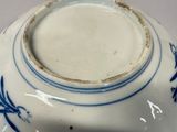 a blue and white vase with a bird design on it