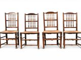 quatre chaises en bois sont alignées sur un fond blanc