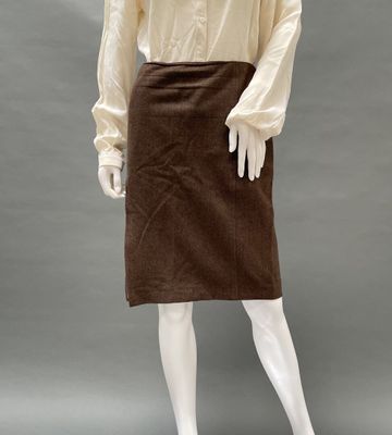 an image of a mannequin wearing a brown skirt and white shirt