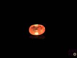 a close up of an orange rock lit up in the dark