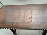 a small table with a wooden top and metal legs