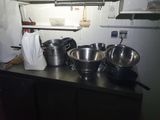 many pots and pans on the counter in the kitchen