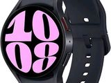 an image of a black smart watch with pink numbers on the face