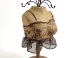 a mannequin with a hat on it on a wooden stand