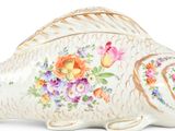 a fish shaped box with flowers and butterflies on it