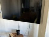 a flat screen tv sitting on a stand in a living room
