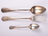 three silver spoons and a fork on a white surface