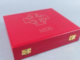 a red box with a cross on it sitting on top of a table
