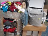a pile of clothes and a computer on a pallet