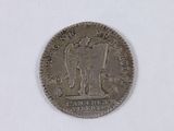 an old indian coin on a white surface with a white background