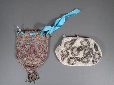two purses that are sitting next to each other on a table