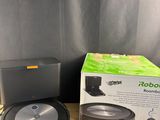 a box of robotic vacuum cleaner next to a box of vacuum cleaner
