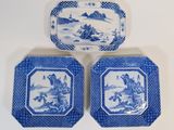 three blue and white plates with designs on them sitting on a table