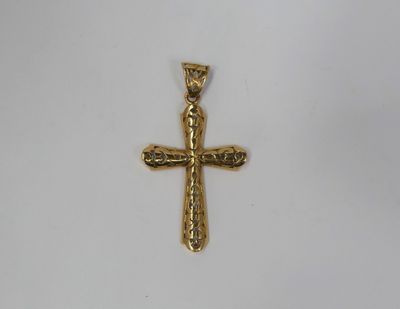 a gold cross pendant on a white background