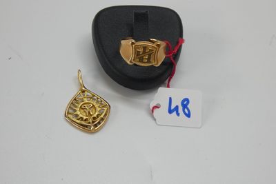 un gros plan sur un pendentif plaqué or et un étui noir