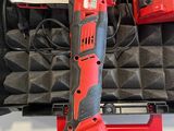 the cordless drill is sitting in a case with other tools in it